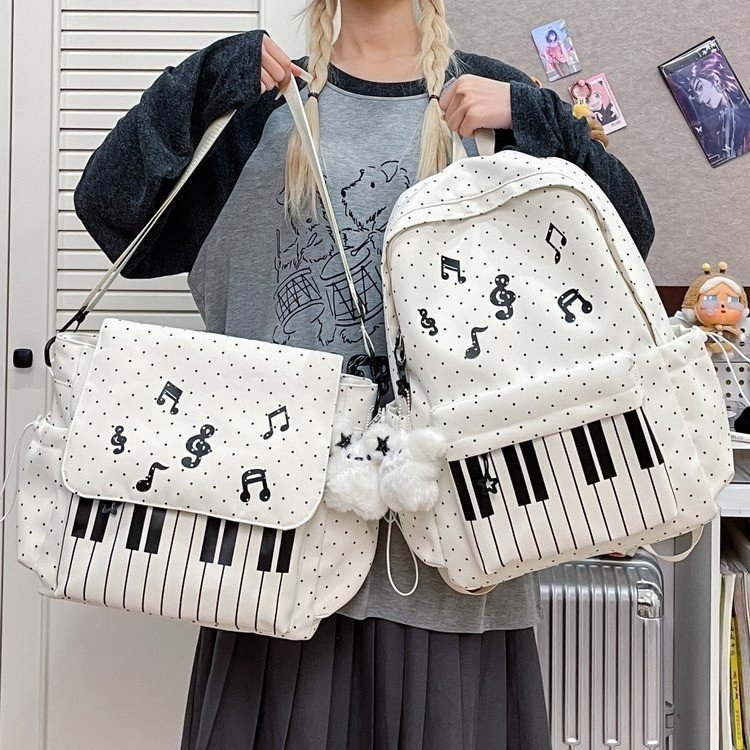 音乐主题双肩包 钢琴键图案 白色波点设计 适合学生日常使用